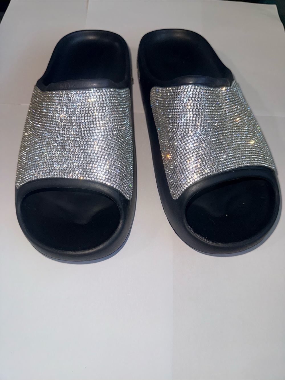 Sparkly black sandals featuring beautiful rhinestone embellishments that add the